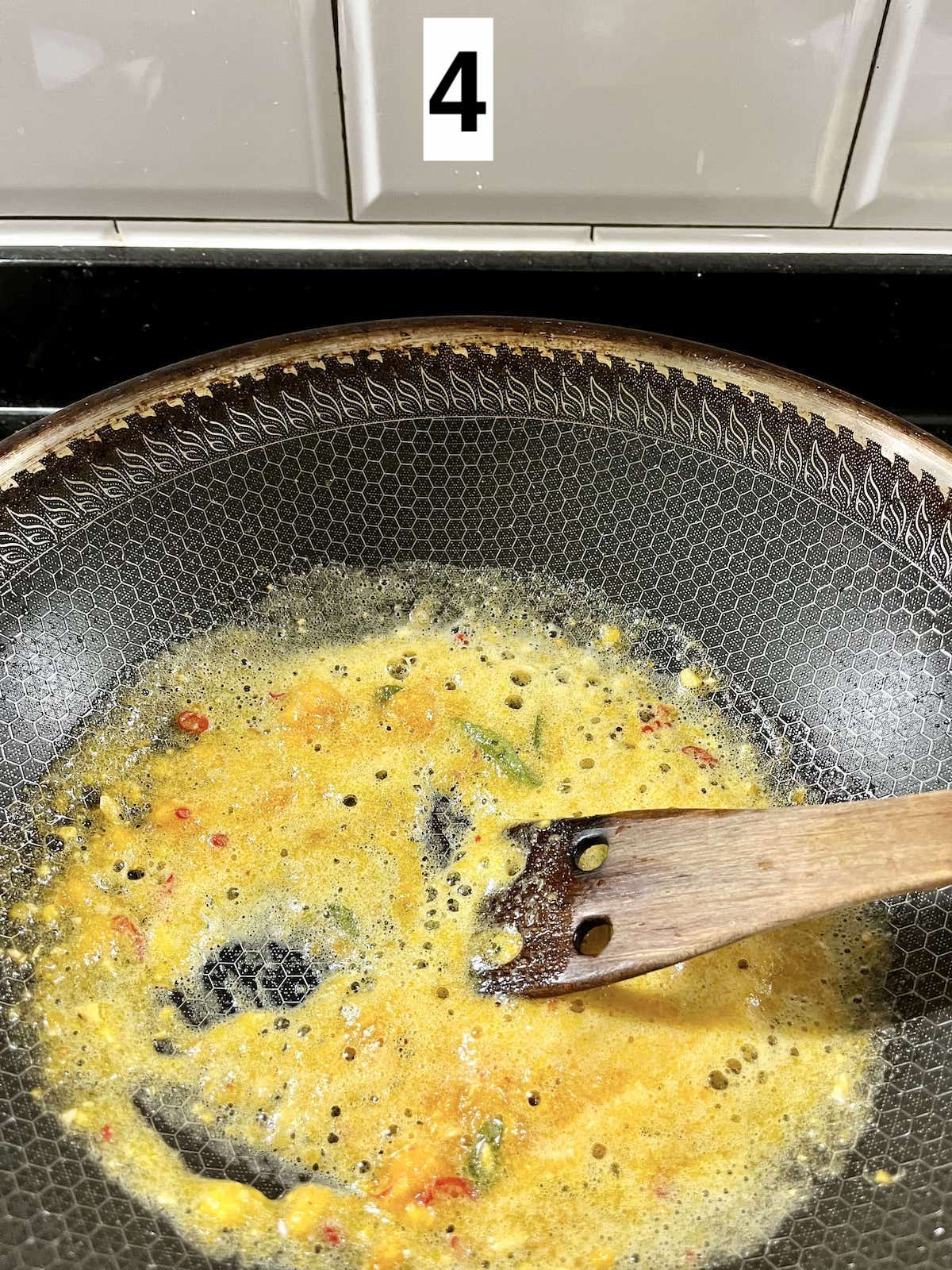 Salted egg yolk sauce bubbling as it is cooked.