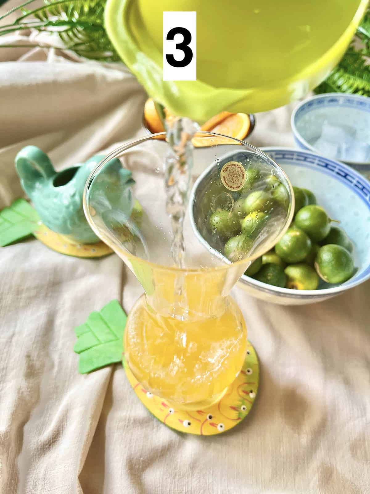 Pouring water into squeezed calamansi lime juice.