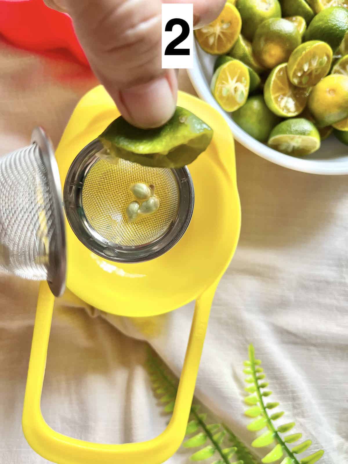 Squeezing halved calamansi limes to get juice.