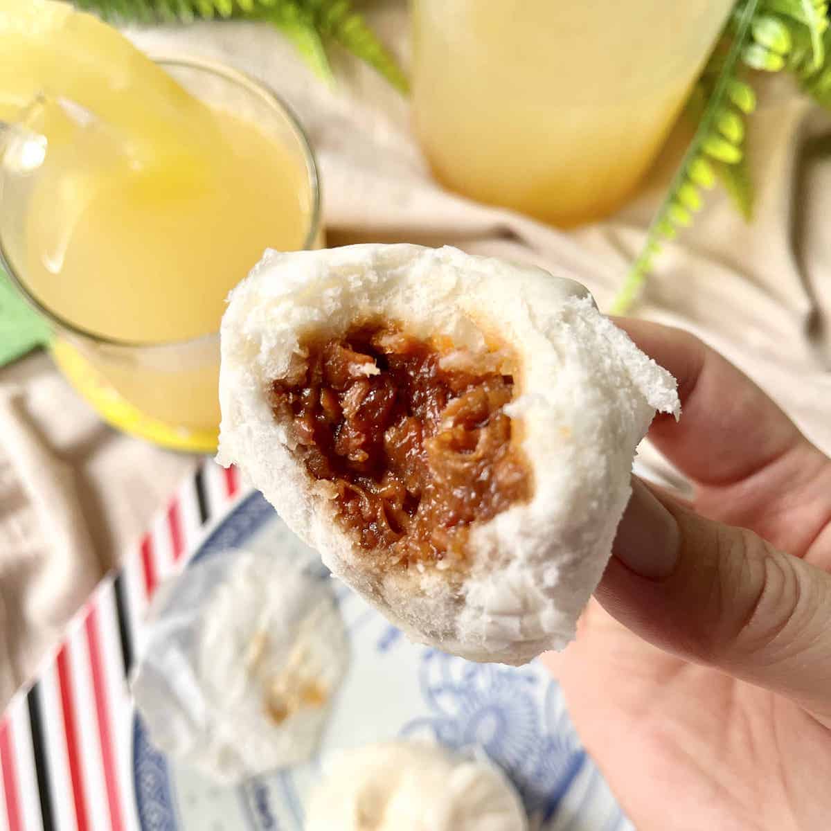 Close-up shot of a half-bitten char siu bao bun.