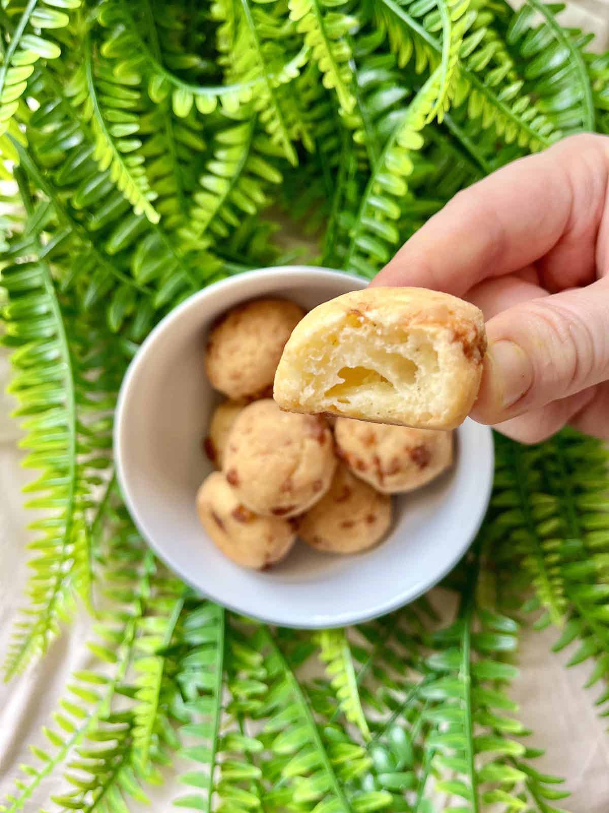 Close-up of a half-bitten mochi cheese bread ball.