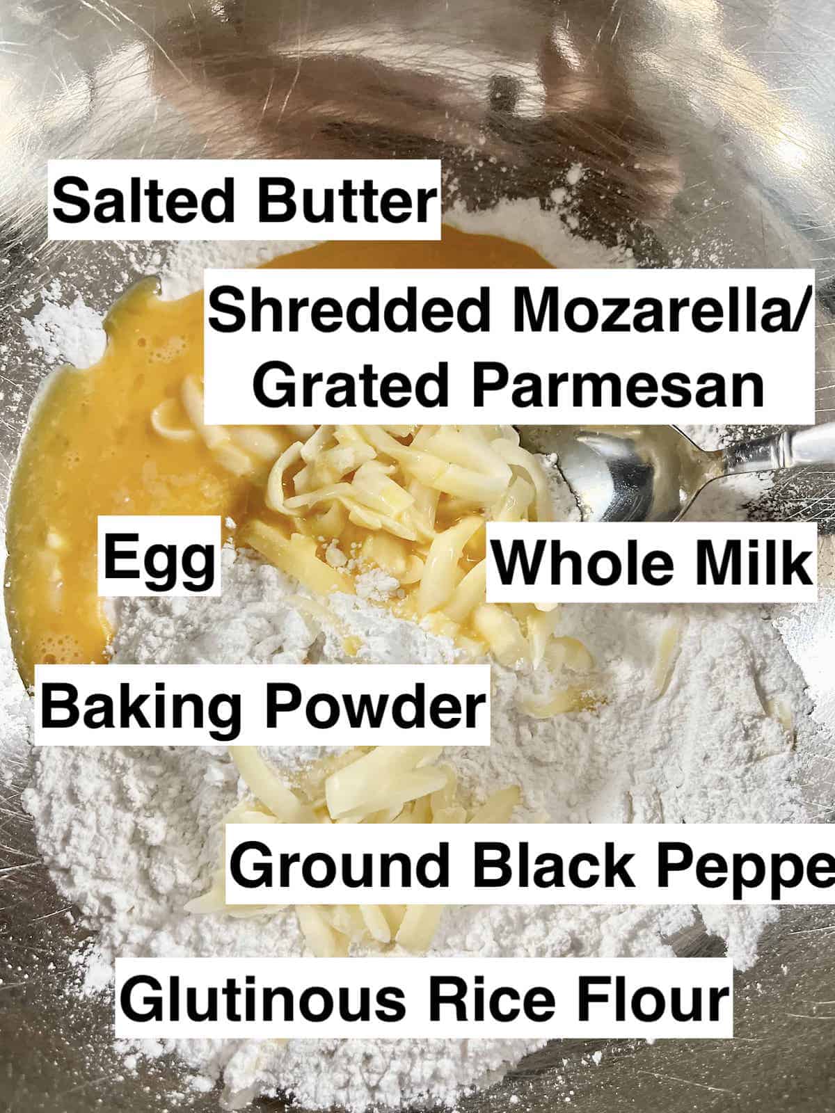The ingredients needed for mochi cheese bread in a silver bowl.