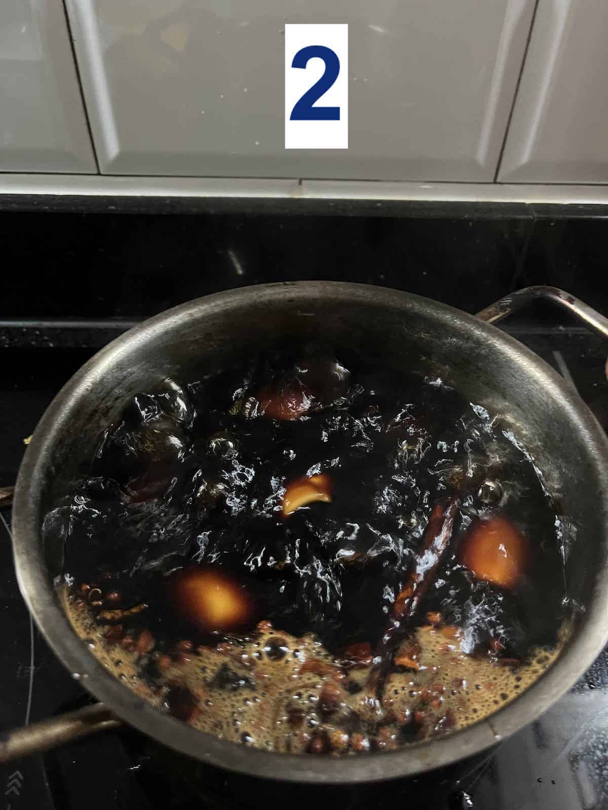 Simmering hard boiled eggs in soy sauce.