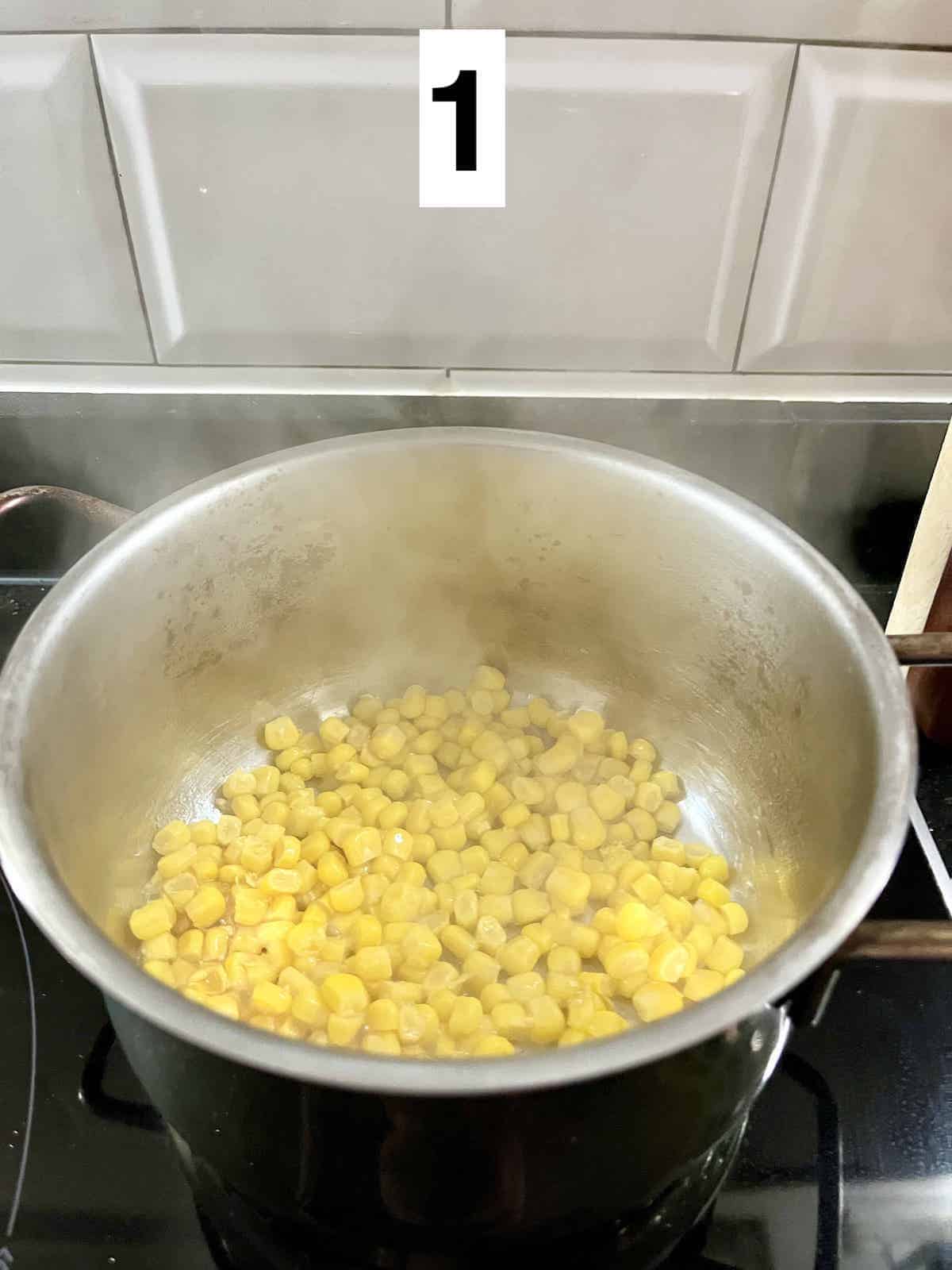 Stir-frying corn kernels in a pot.