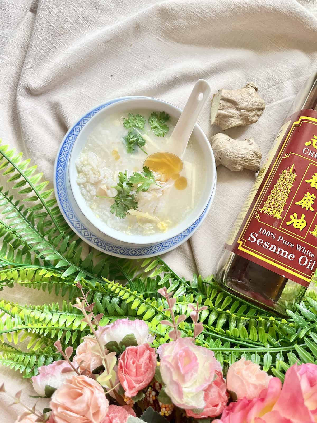 A bowl of Chinese congee with coriander and sesame oil.