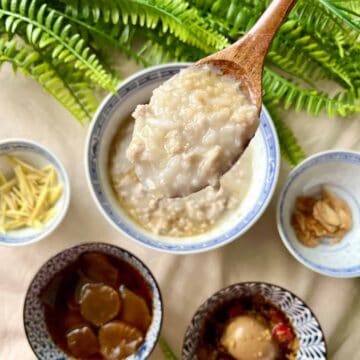 Close-up of a spoonful of ground pork rice porridge with sesame oil.