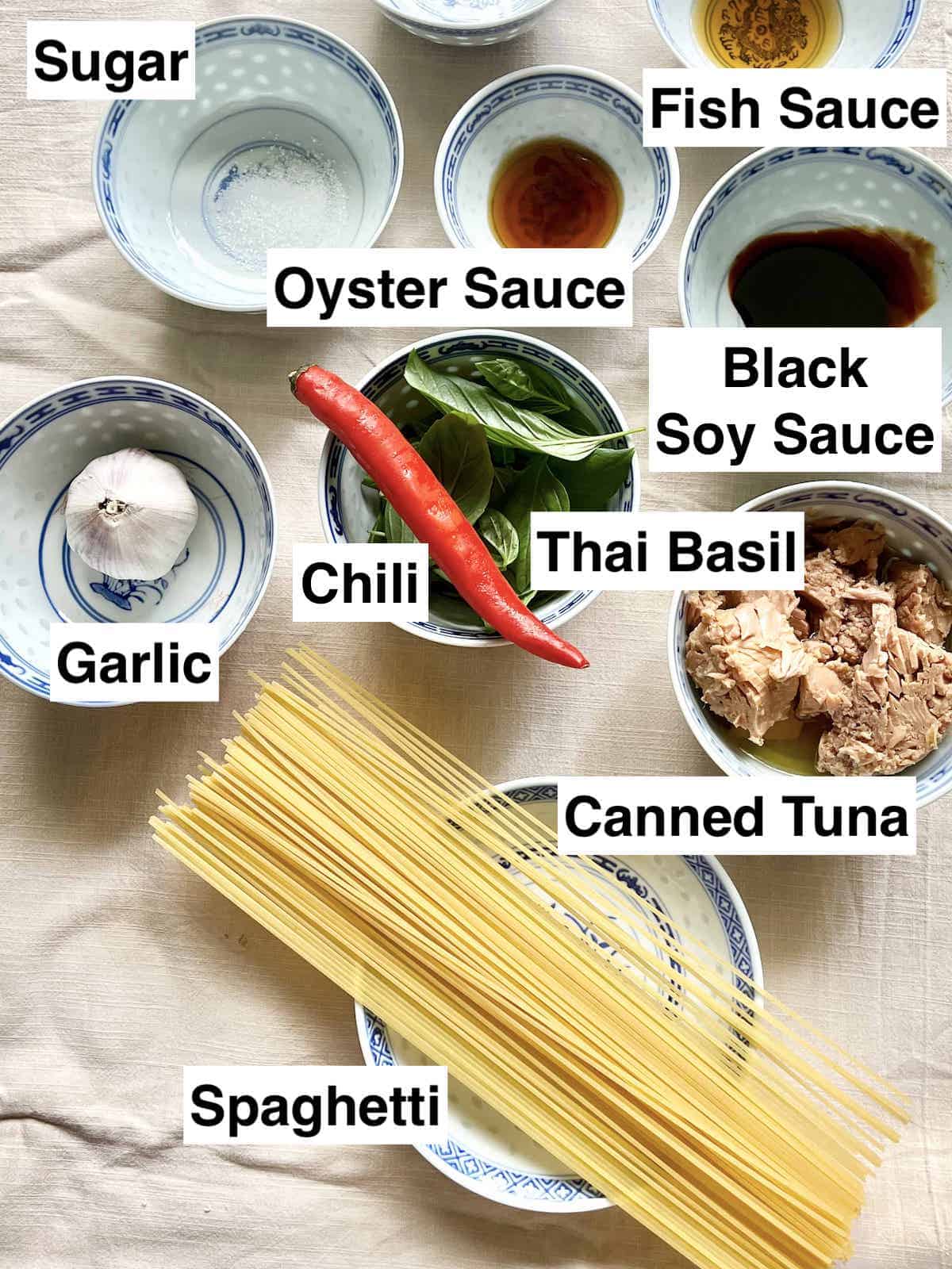 The ingredients needed to make Thai Drunken Noodles on a linen cloth.