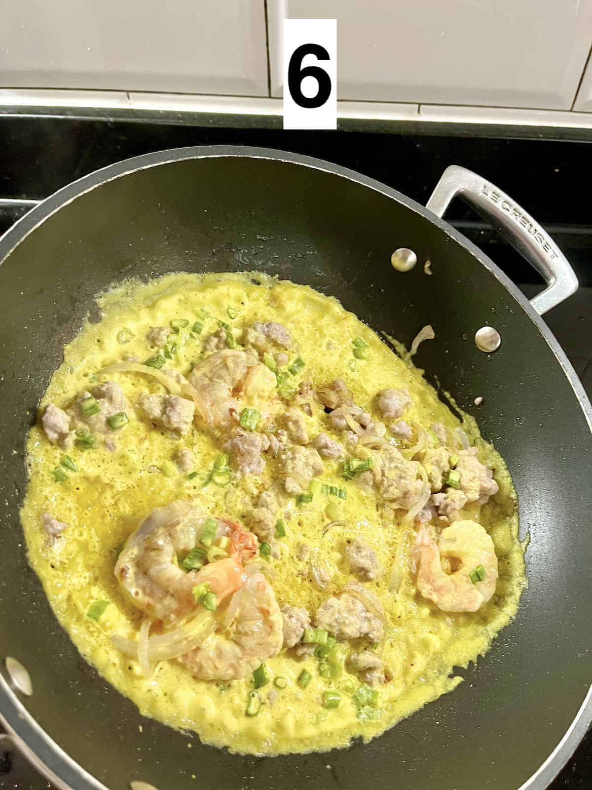 Swirling pancake batter in a hot pan.