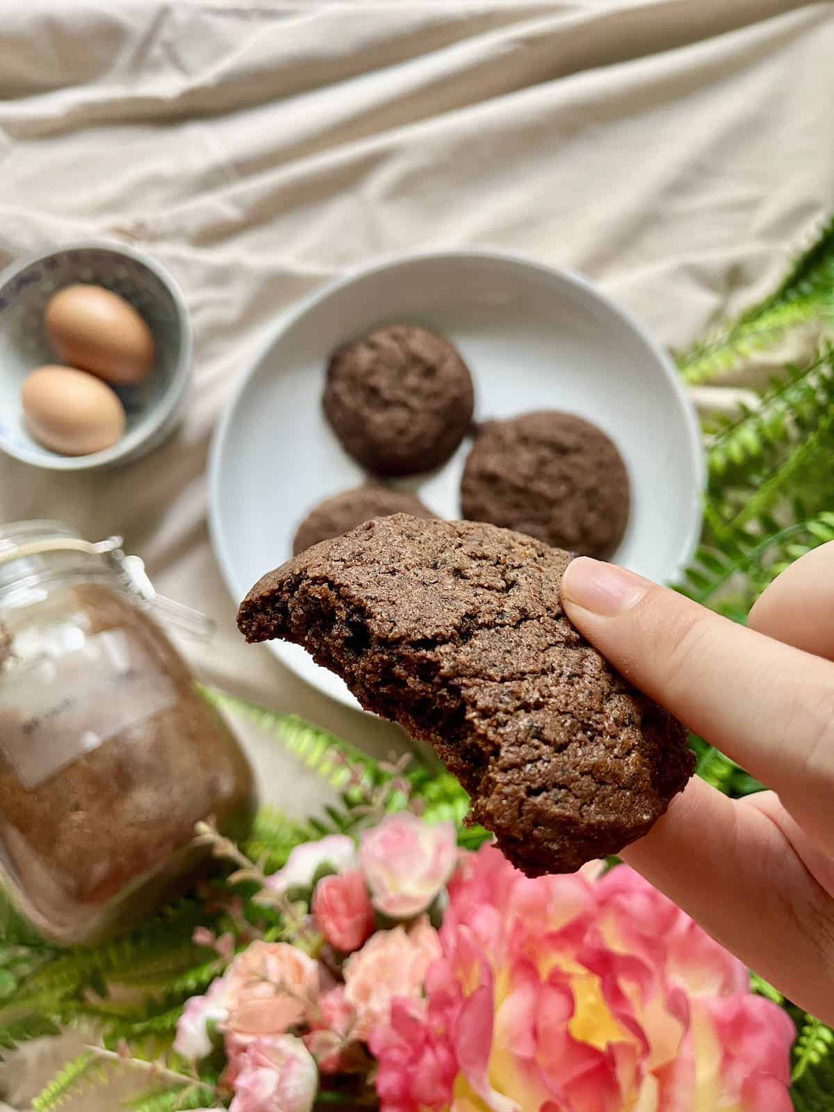 Half-eaten black sesame cookie with chocolate.