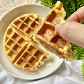 Holding up a slice of cheese waffle mochi.