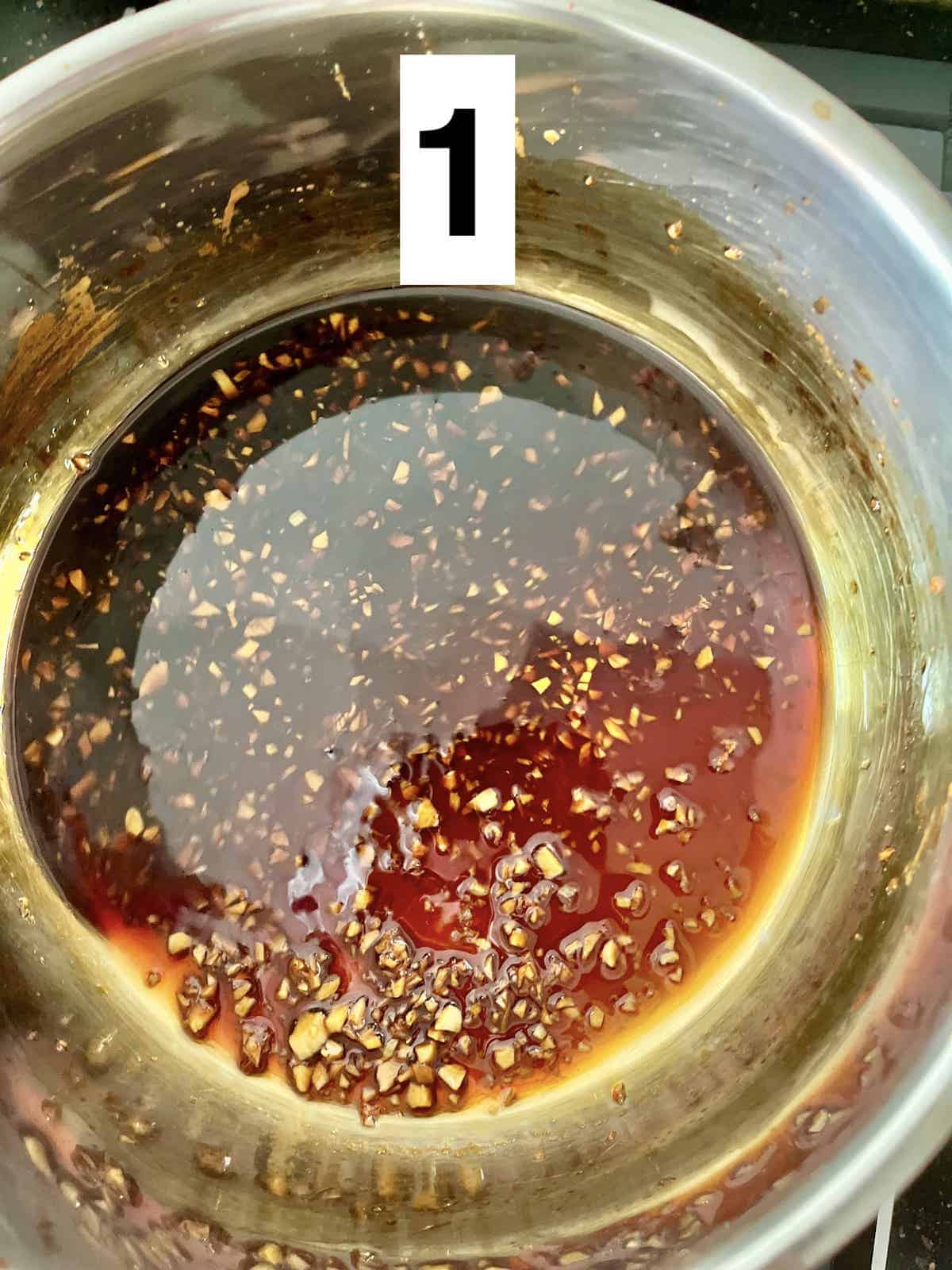 Homemade teriyaki sauce and minced garlic in a pot.