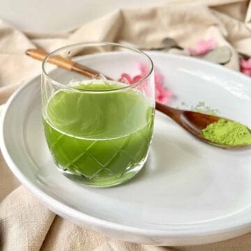 A glass of vibrant green matcha tea.