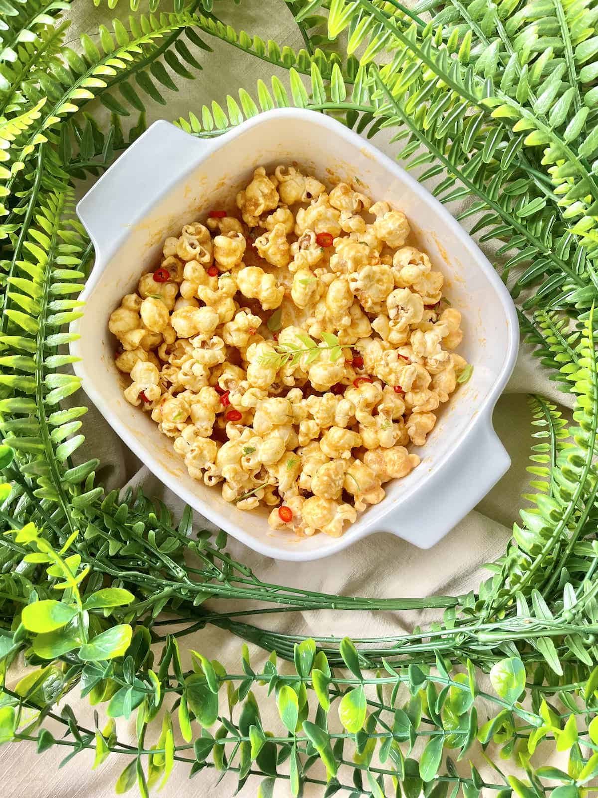 A bowl full of homemade golden yellow salted egg popcorn snacks.