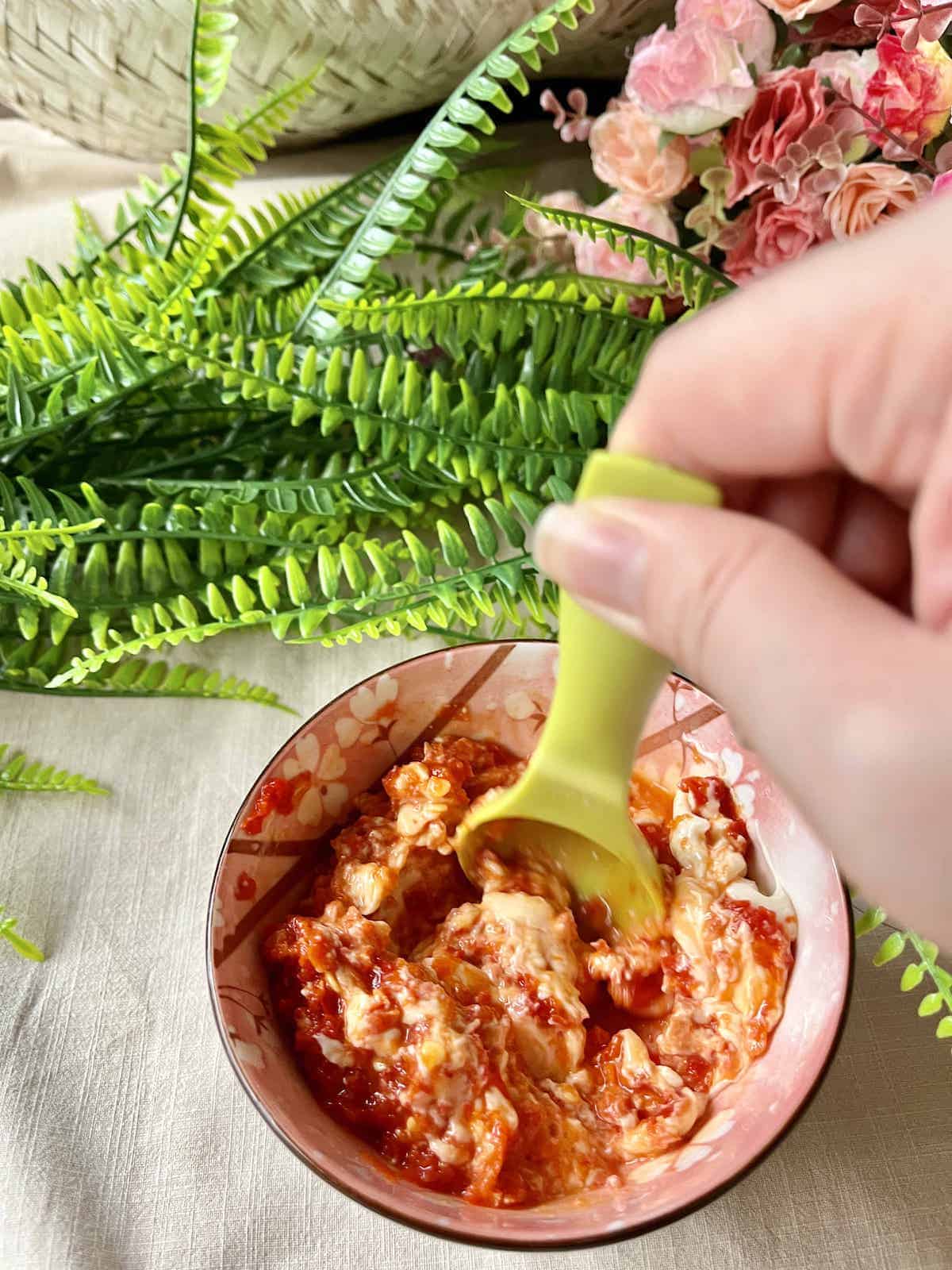 Stirring sambal aioli, made with homemade sambal oelek.