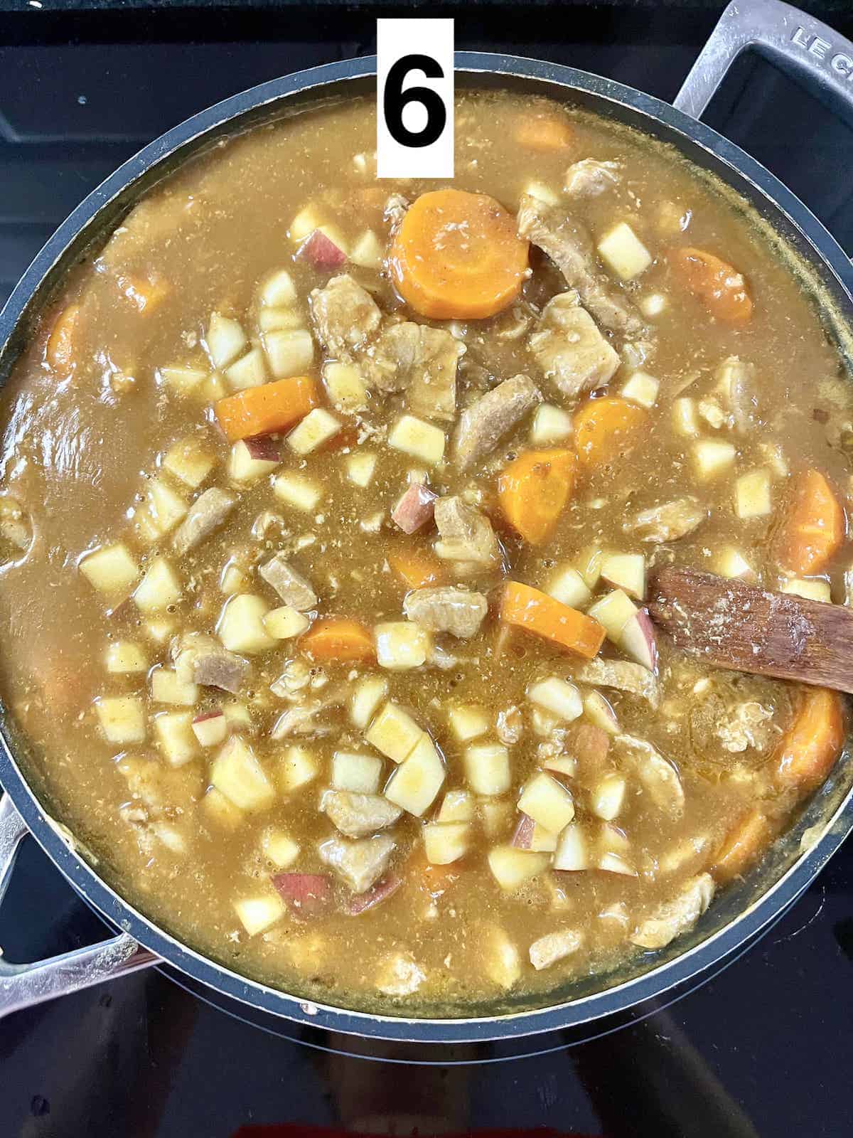A pan of simmering Japanese pork and carrot curry.