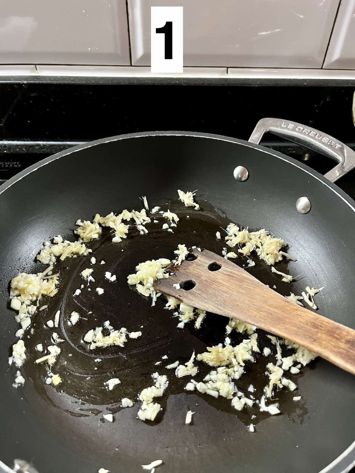 Sautéing aromatics in a Le Creuset pan.