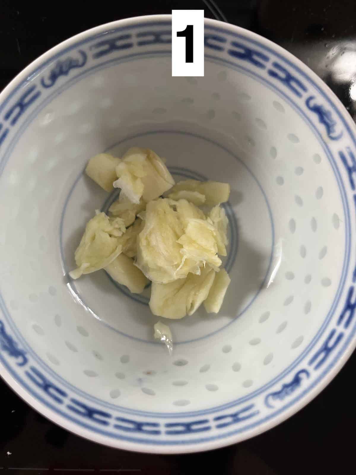 Smashed garlic in a bowl.