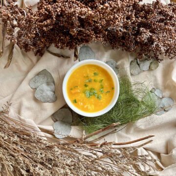 A bowl of bright orange leftover pumpkin puree Chinese porridge jook.