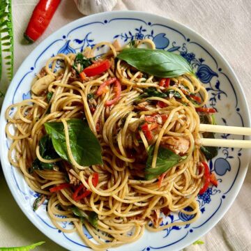 Close-up of a plate of spicy Thai basil spaghetti.