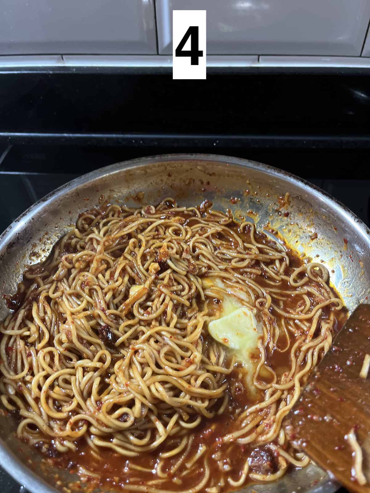 Butter melting into a pan of gochujang noodles.