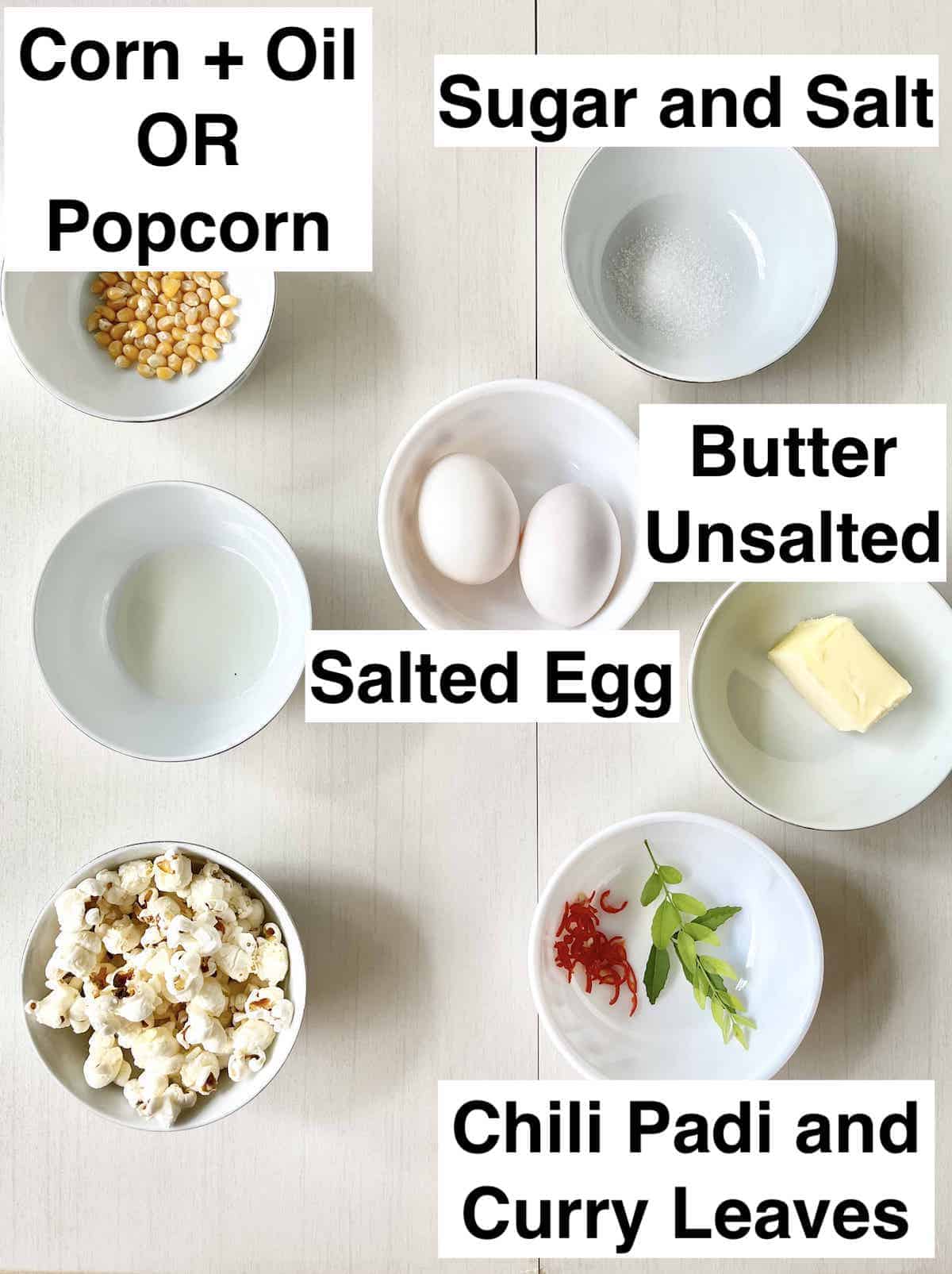 The ingredients for salted egg popcorn next to each other in bowls.