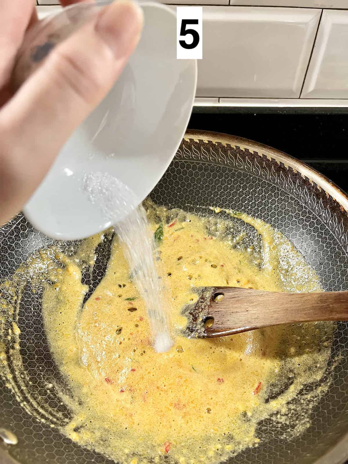 Adding sugar to the salted ducks egg sauce.