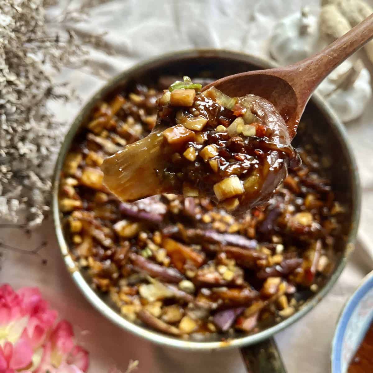 A skillet full of eggplants and mushrooms tossed in spicy doubanjiang.