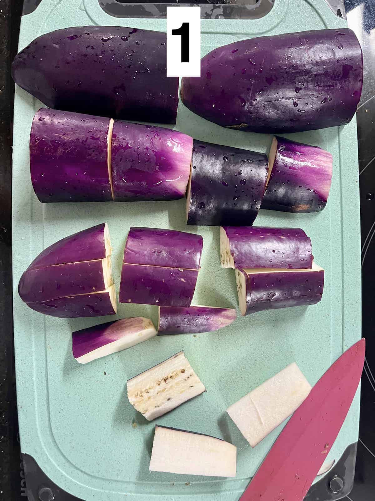 Cutting up eggplants on a cutting board.