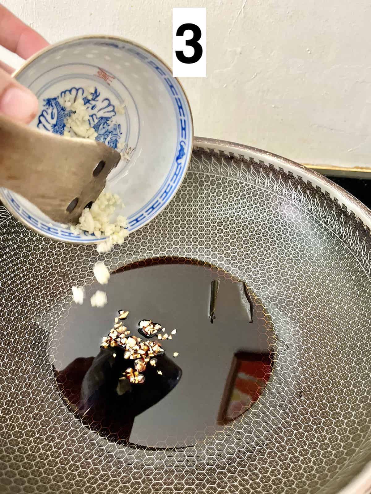 Stir-frying garlic in teriyaki sauce.