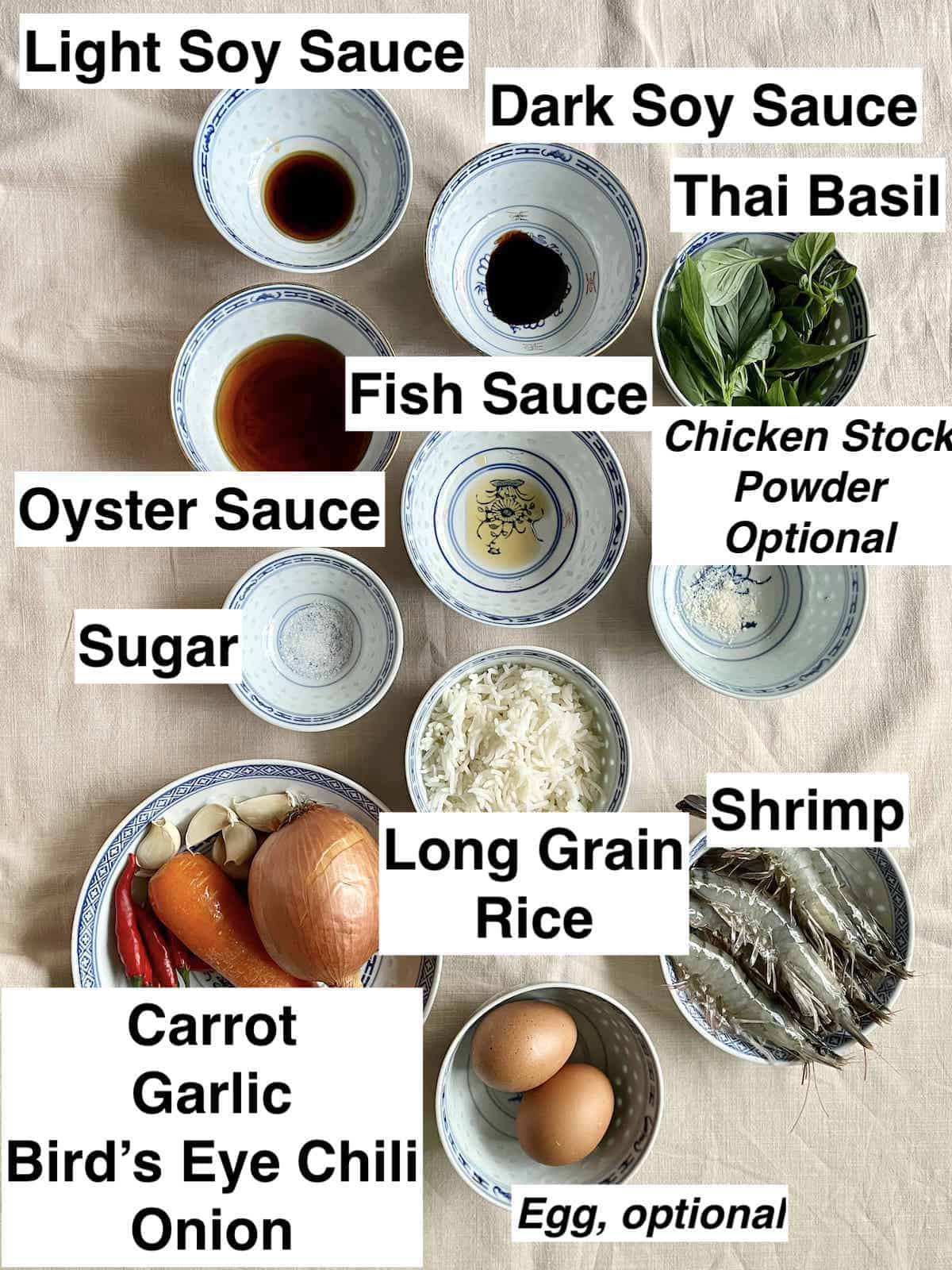 The ingredients needed for Thai Shrimp Fried Rice on a linen cloth.