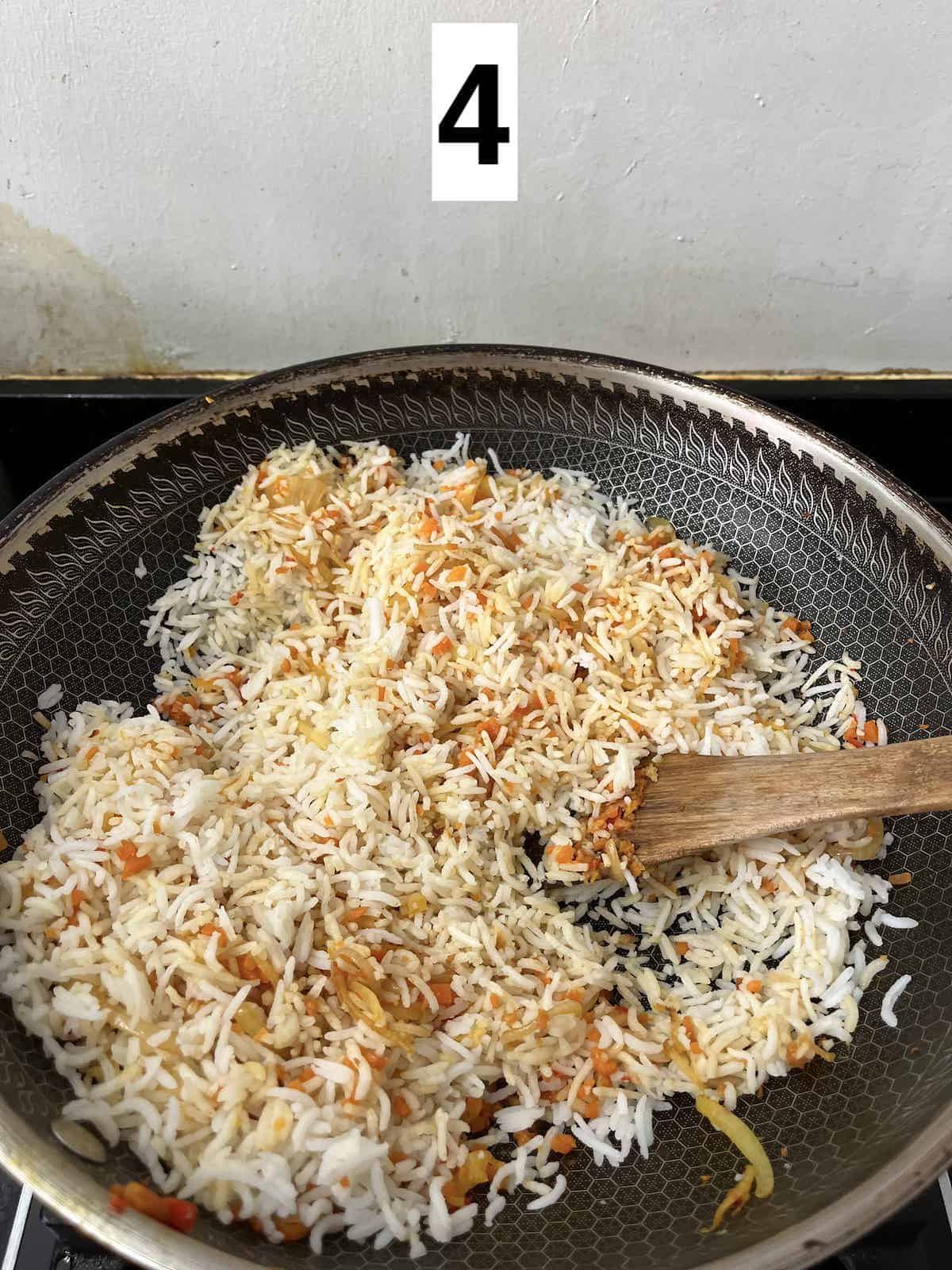 Stir-frying rice in a wok.