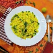 Yellow lemon rice on a white plate.