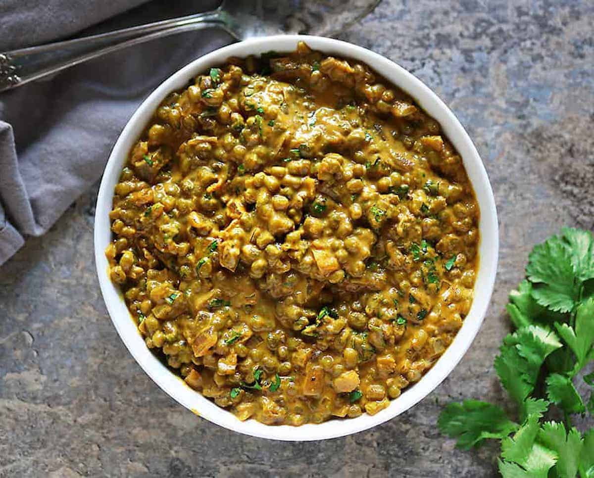 A bowl of green mung bean curry.