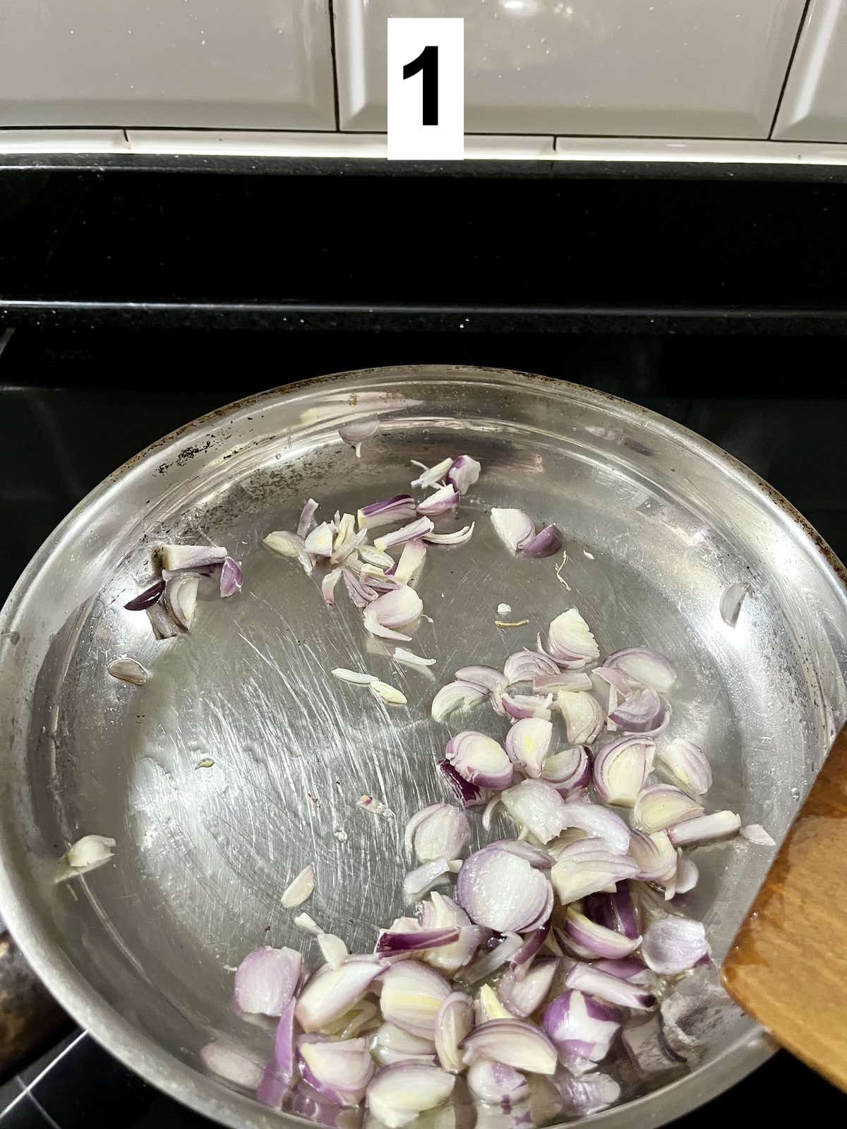 Stir-frying sliced shallots.