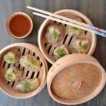 2 steamed bamboo baskets with chicken momo dumplings