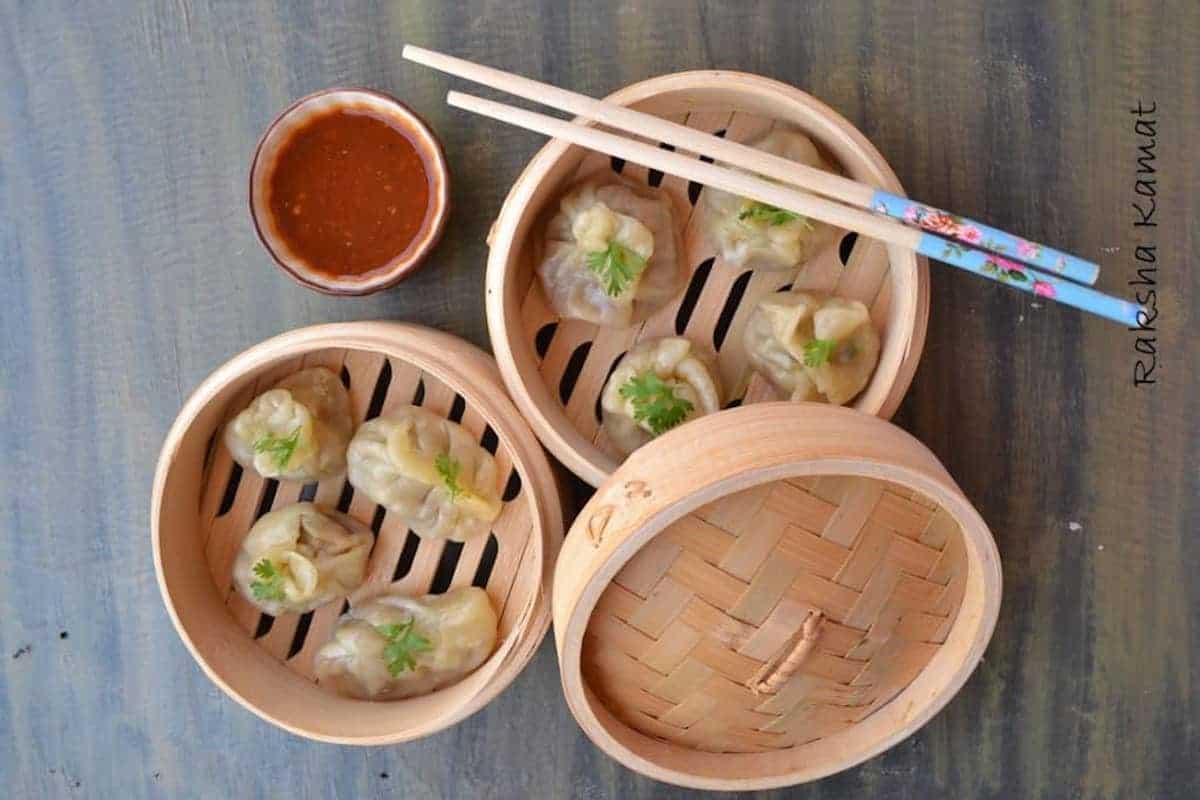 2 steamed bamboo baskets with chicken momo dumplings