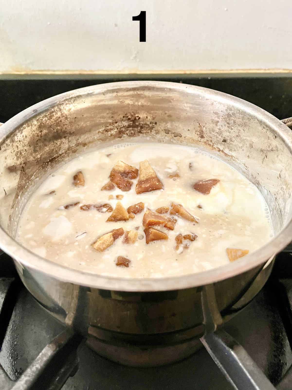 Coconut milk, gula melaka sugar and water being cooked down in a pot.