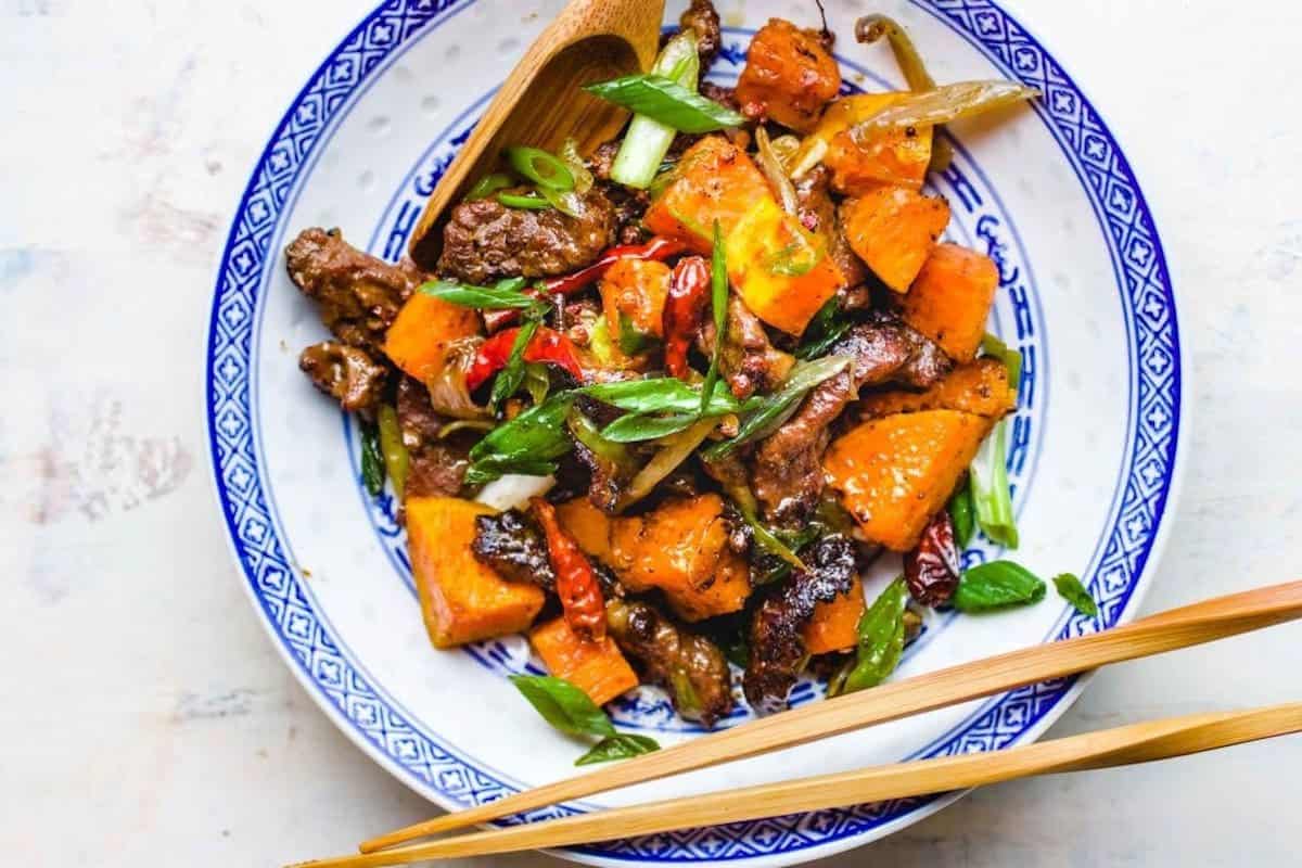 Beef and butternut squash stir-fried with cumin.