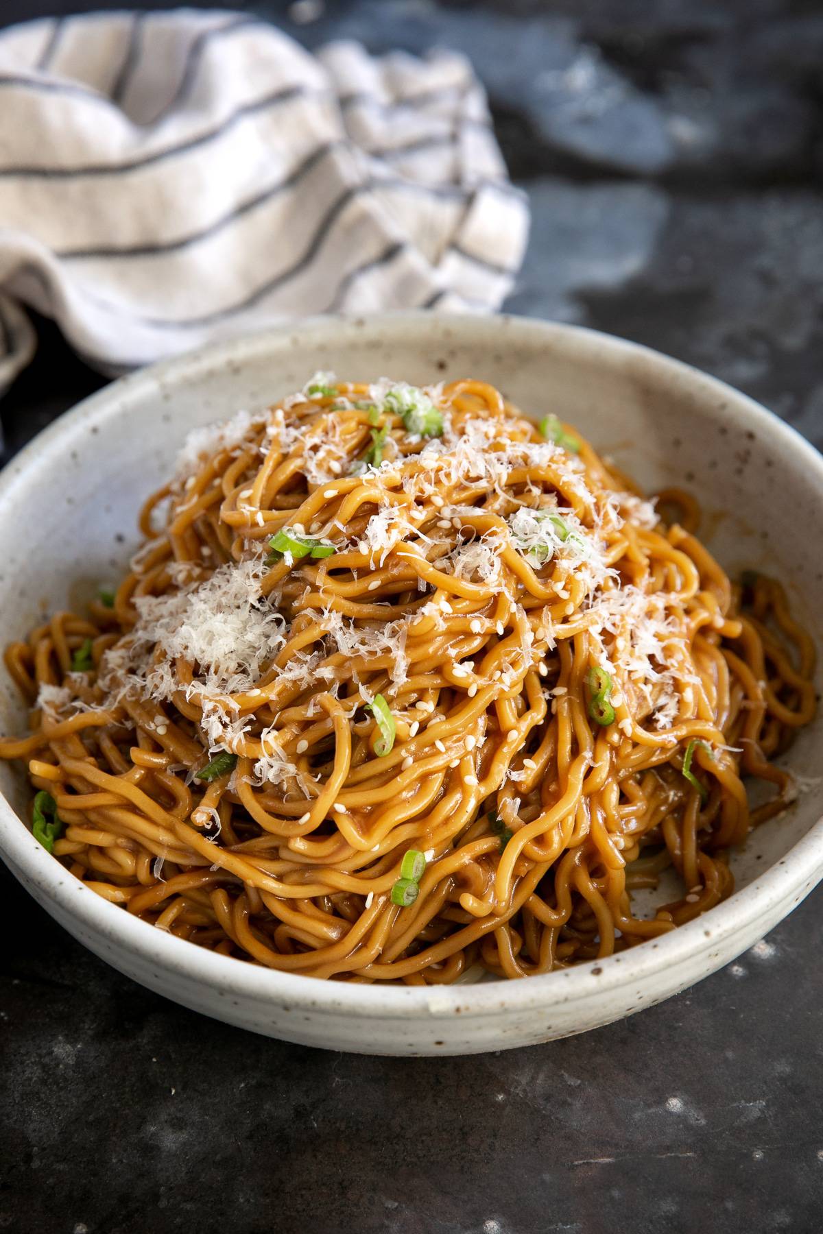 A bowl of garlic soy noodles with cheese