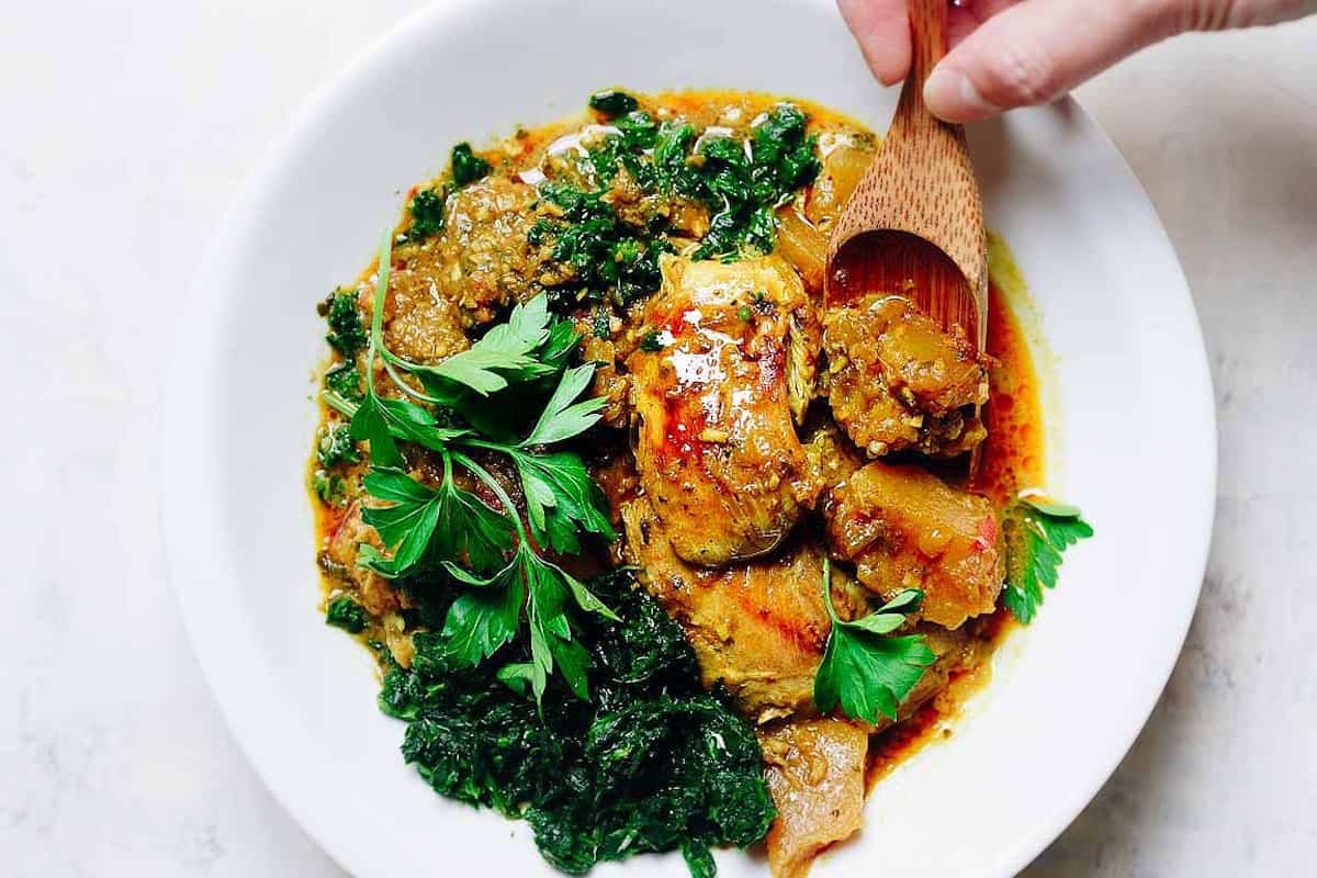 A colourful bowl of pumpkin chicken curry.