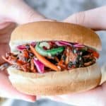 Close-up of someone holding Korean Sliders made with young jackfruit