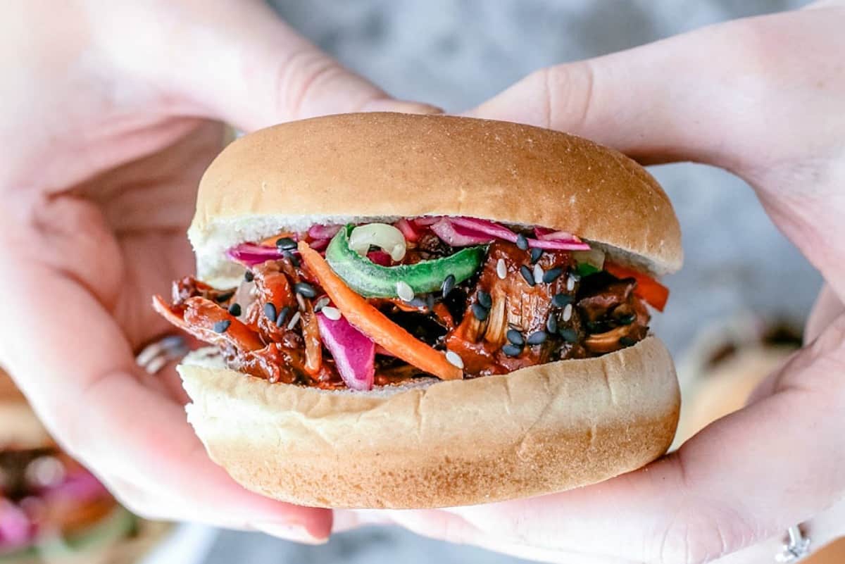 Close-up of someone holding Korean Sliders made with young jackfruit