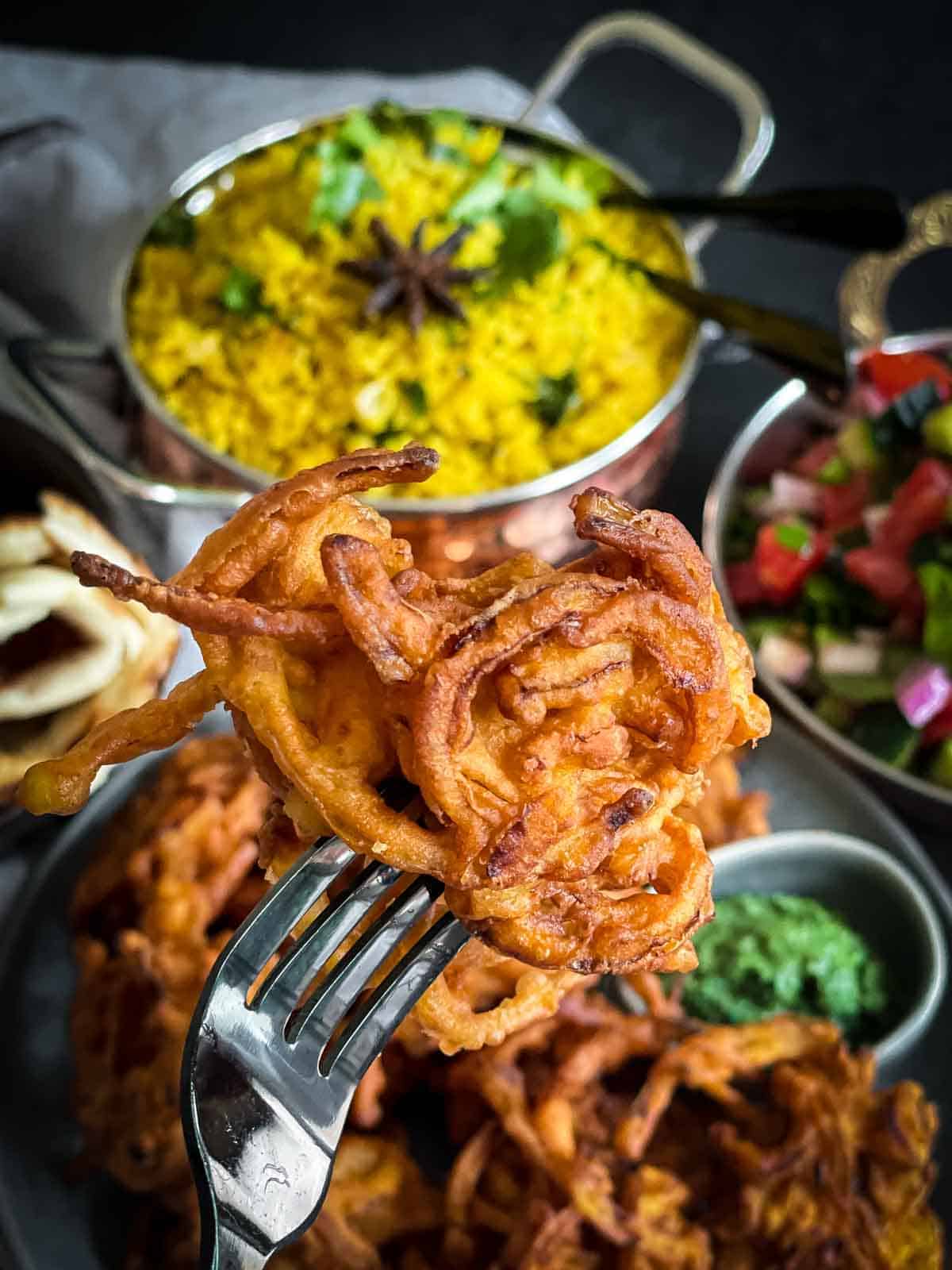 A fork picking up an onion bhaji