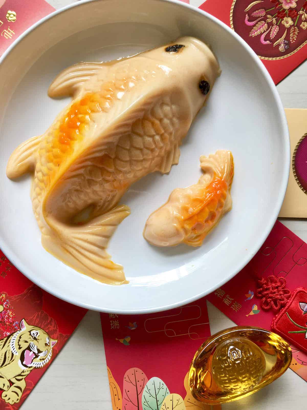 Close-up of koi fish jelly with Chinese New Year decorations in the background