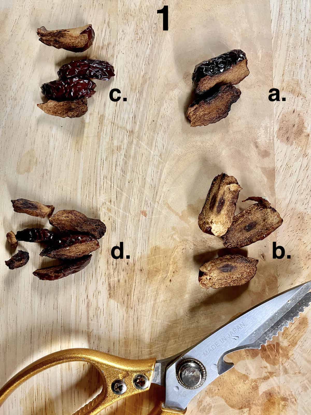 Snipping the flesh of a dried red date using a pair of scissors.