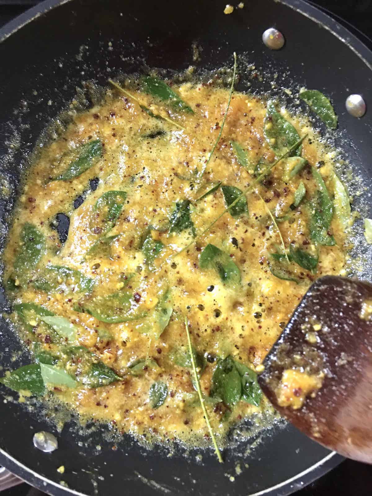 Bubbling salted egg yolk sauce in a pan.