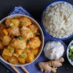 A chinese new year feast on the table with fish and rice and greens