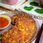 Several brown Thai corn fritters on a fully laid out table