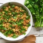 A plate of turmeric fried rice and greens.