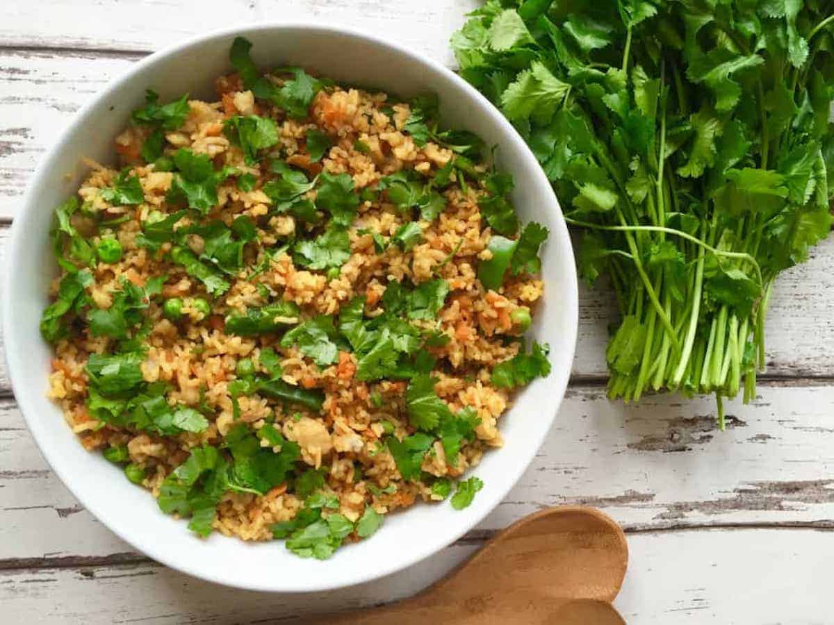 A plate of turmeric fried rice and greens.